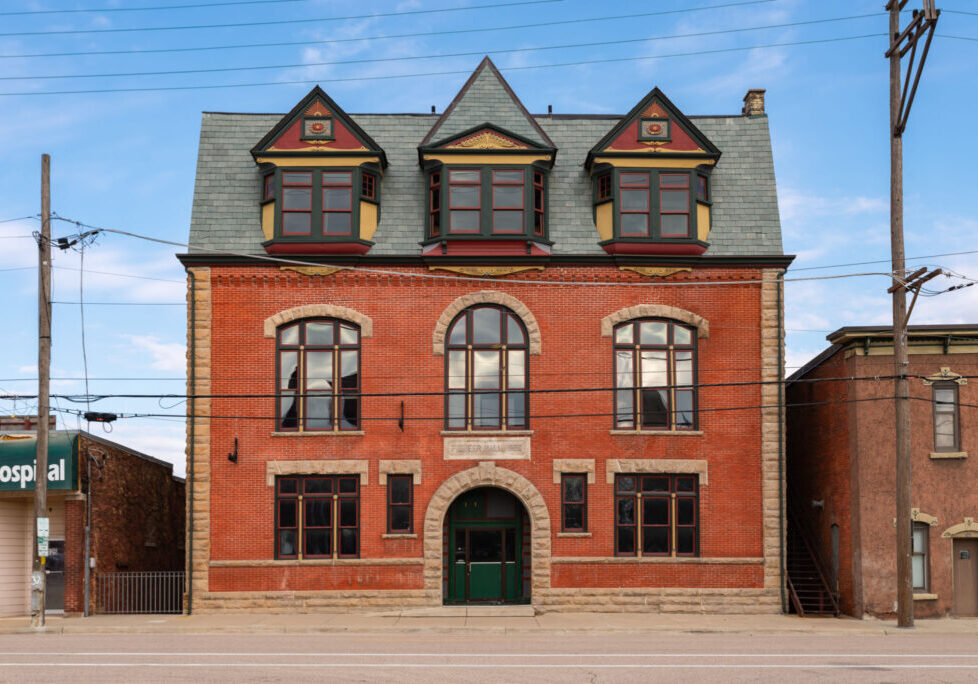 Historic red brick building with arched windows.